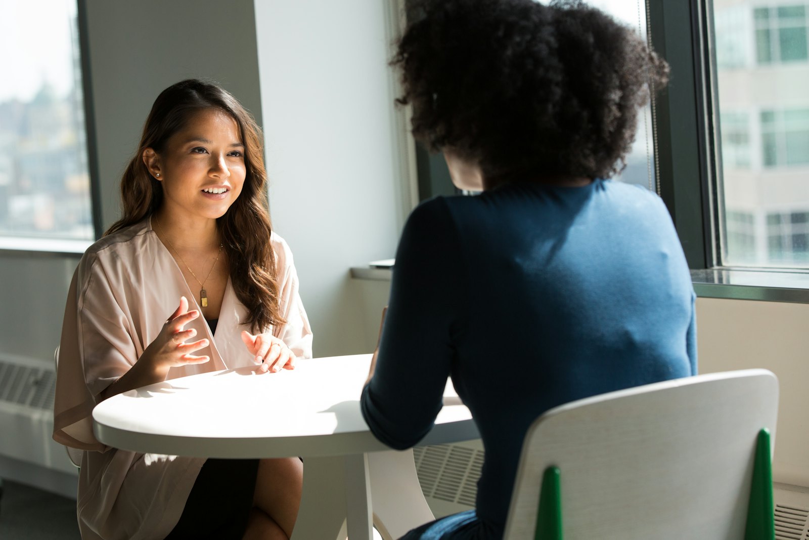 Two people mid-conversation in a private Fin-Uwezo consultation room